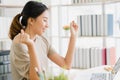 Beautiful young smiling asian woman working laptop on desk in living room at home. Royalty Free Stock Photo