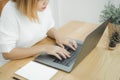 Beautiful young smiling Asian woman working on laptop while at home in office work space. Royalty Free Stock Photo