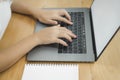 Beautiful young smiling Asian woman working on laptop while at home in office work space. Royalty Free Stock Photo