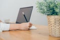 Beautiful young smiling asian woman working on laptop while sitting in a living room at home. Asian business woman working in her Royalty Free Stock Photo