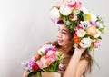 Beautiful young smiling model with bright flowers on her head Royalty Free Stock Photo