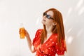 Beautiful woman drinking orange juice while sitting outdoors Royalty Free Stock Photo