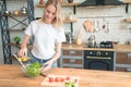 Beautiful young smiling woman making salad in the kitchen. Healthy food. vegetable salad. Diet. Healthy lifestyle. cooking at home Royalty Free Stock Photo