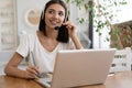 Beautiful young smiling woman working on laptop from home office space Royalty Free Stock Photo