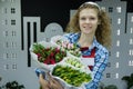 Beautiful young smilling woman florist are selling the bouqet of the tulips in flower shop