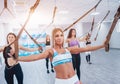 Beautiful young sports women are working out with TRX in gym Royalty Free Stock Photo