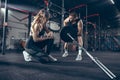 Beautiful young sporty couple training, workout in gym together Royalty Free Stock Photo