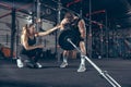 Beautiful young sporty couple training, workout in gym together Royalty Free Stock Photo