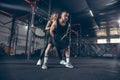 Beautiful young sporty couple training, workout in gym together Royalty Free Stock Photo