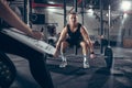 Beautiful young sporty couple training, workout in gym together Royalty Free Stock Photo