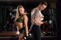 Beautiful young sporty sexy couple showing muscle and workout in gym. Royalty Free Stock Photo