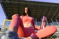 Beautiful young sporty woman drinking water after running. Fit jogger girl taking a break after sport. Lifestyle, people, sport Royalty Free Stock Photo