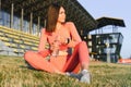 Beautiful young sporty woman drinking water after running. Fit jogger girl taking a break after sport. Lifestyle, people, sport Royalty Free Stock Photo
