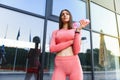 Beautiful young sporty woman drinking water after running. Fit jogger girl taking a break after sport. Lifestyle, people, sport Royalty Free Stock Photo