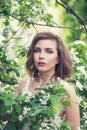 Beautiful young spring woman in white flowers in blooming garden Royalty Free Stock Photo