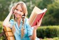 Beautiful young student girl reading book Royalty Free Stock Photo