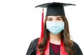 Beautiful young student graduating with a face mask Royalty Free Stock Photo