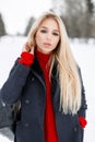 Beautiful young stylish girl in a trendy winter coat with