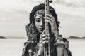 Beautiful young stylish tribal woman in oriental costume playing sitar outdoors. Close up