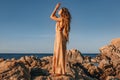 Beautiful young stylish woman on the beach