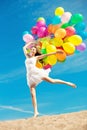 Beautiful young stylish woman with multi-colored rainbow balloon