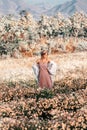 Beautiful young stylish woman posing on the field at sunset Royalty Free Stock Photo