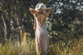 Beautiful young stylish woman posing on the field at sunset portrait Royalty Free Stock Photo