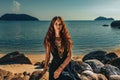 Beautiful young stylish woman at sunset at the beach