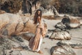 Beautiful young stylish woman walking on the beach at sunset Royalty Free Stock Photo