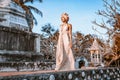 Beautiful young stylish woman wearing flowers wreath outdoors at sunset Royalty Free Stock Photo