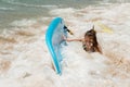 Beautiful young surfer girl falling off the surfboard