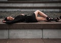 Beautiful young svelte sexy attractive German female model posing on the wall in a black dress Royalty Free Stock Photo