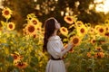 Beautiful woman in a dress in a field of sunflowers Royalty Free Stock Photo