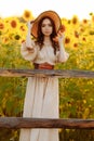 Beautiful woman in a dress and hat a field of sunflowers Royalty Free Stock Photo