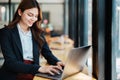 Beautiful young teen asian businesswoman using laptop computer and paperworks with planning working on financial Royalty Free Stock Photo