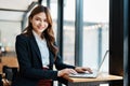 Beautiful young teen asian businesswoman using laptop computer and paperworks with planning working on financial Royalty Free Stock Photo