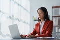 Beautiful young teen asian businesswoman using laptop computer and paperworks with planning working on financial Royalty Free Stock Photo