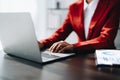 Beautiful young teen asian businesswoman using laptop computer and paperworks with planning working on financial Royalty Free Stock Photo