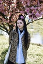 beautiful young teen girl in spring blooming cherry blossoms garden Royalty Free Stock Photo