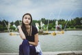 Beautiful young teen girl sits near the fountain. The concept of tourism and leisure Royalty Free Stock Photo