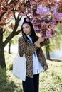 young teen girl in spring blooming cherry blossoms garden Royalty Free Stock Photo