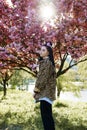 beautiful young teen girl in spring blooming cherry blossoms garden Royalty Free Stock Photo