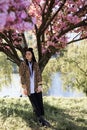 beautiful young teen girl in spring blooming cherry blossoms garden Royalty Free Stock Photo