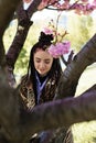 beautiful young teen girl in spring blooming cherry blossoms garden Royalty Free Stock Photo