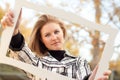 Beautiful Young Teen Smiling in the Park with Picture Frame Royalty Free Stock Photo