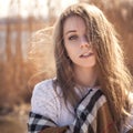 Beautiful young teenage caucasian woman in a plaid walking think Royalty Free Stock Photo