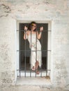 Beautiful Young Teenage Girl in Old Stone Jail Window