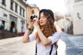 Beautiful young tourist with camera in the old town. Royalty Free Stock Photo