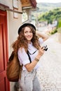 Beautiful young tourist with camera in the old town. Royalty Free Stock Photo