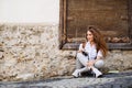 Beautiful young tourist with camera in the old town. Royalty Free Stock Photo